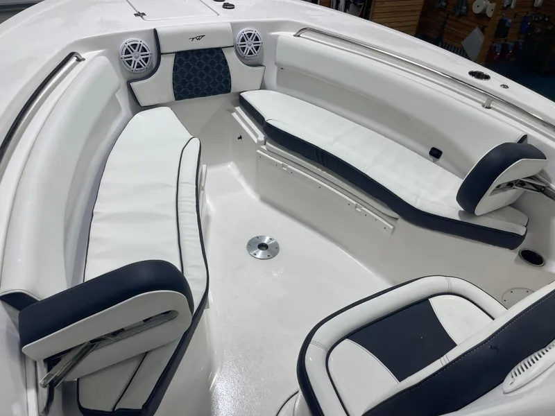Slide: The Image of 2023 Tidewater 232cc boat interior with white and navy seating, featuring speakers and sleek design. - 26