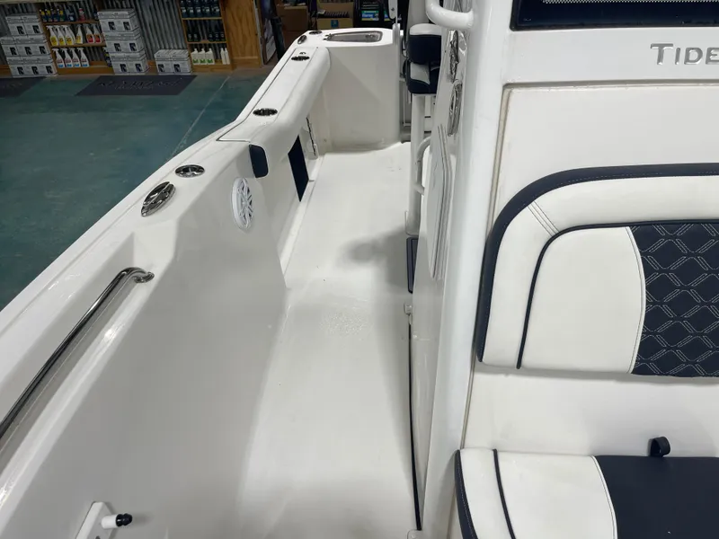 Slide: The Image of 2023 Tidewater 232cc boat interior with white seating and stainless steel fixtures. - 27