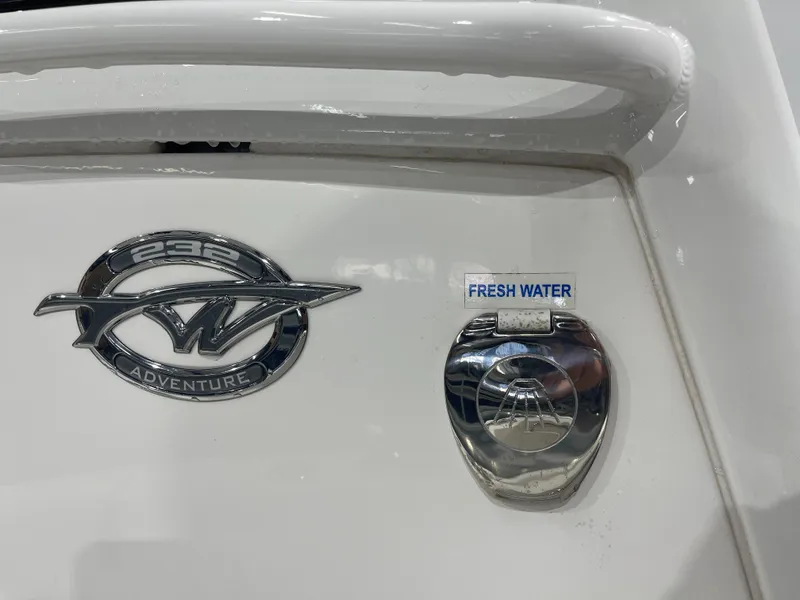 Slide: The Image of 2023 Tidewater 232cc boat emblem and fresh water access point. - 30