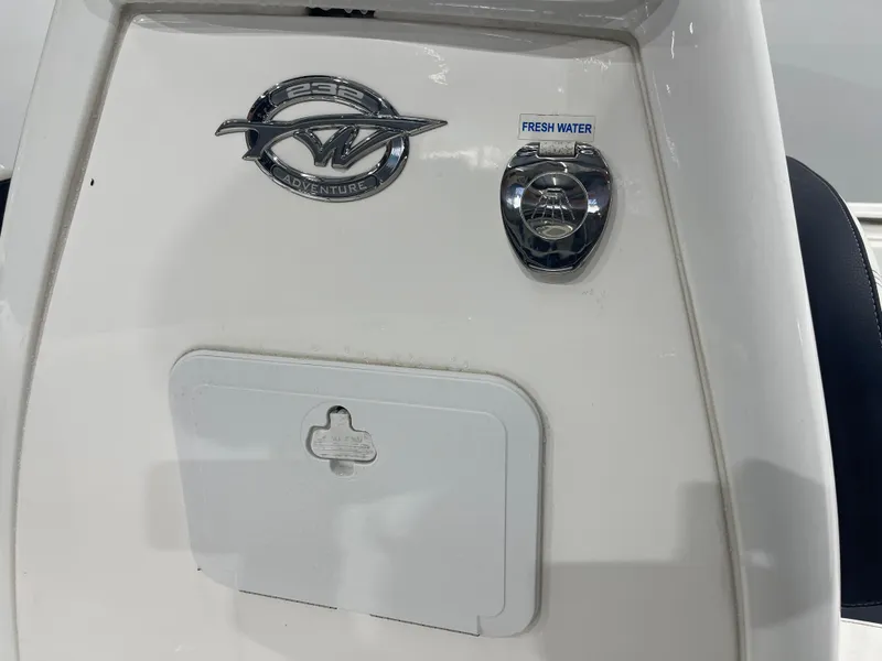 Slide: The Image of Tidewater 232cc 2023 boat detail with fresh water access and emblem. - 31