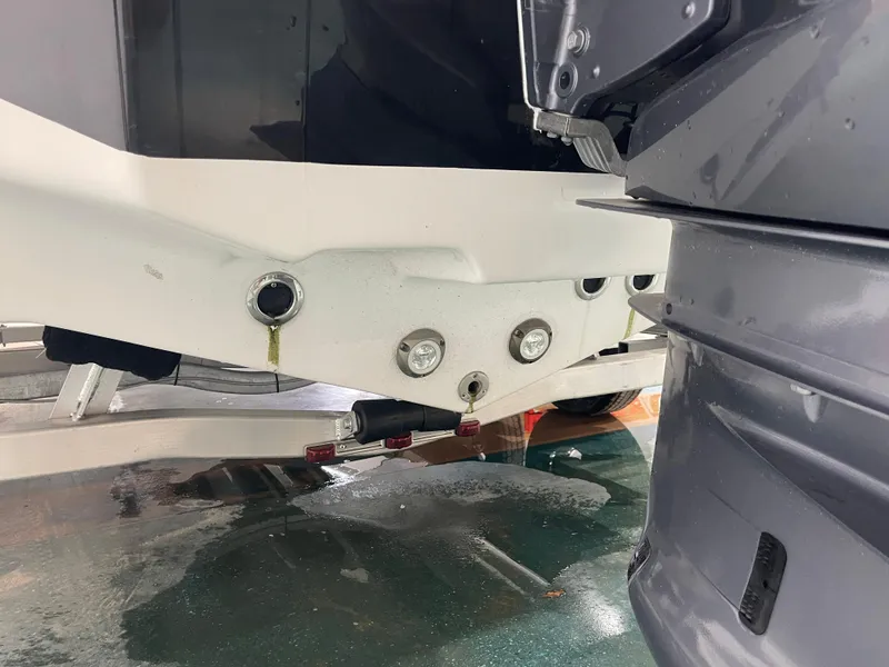 Slide: The Image of 2023 Tidewater 232cc boat on trailer, showing hull and engine details. - 35