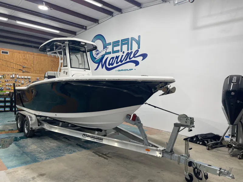 Slide: The Image of 2023 Tidewater 232cc boat on trailer in showroom, Ocean Marine Group. - 5