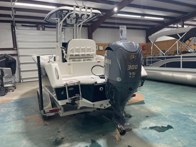 Slide: The Image of 2023 Tidewater 232cc boat with Yamaha 300 V6 engine in a showroom. - 6