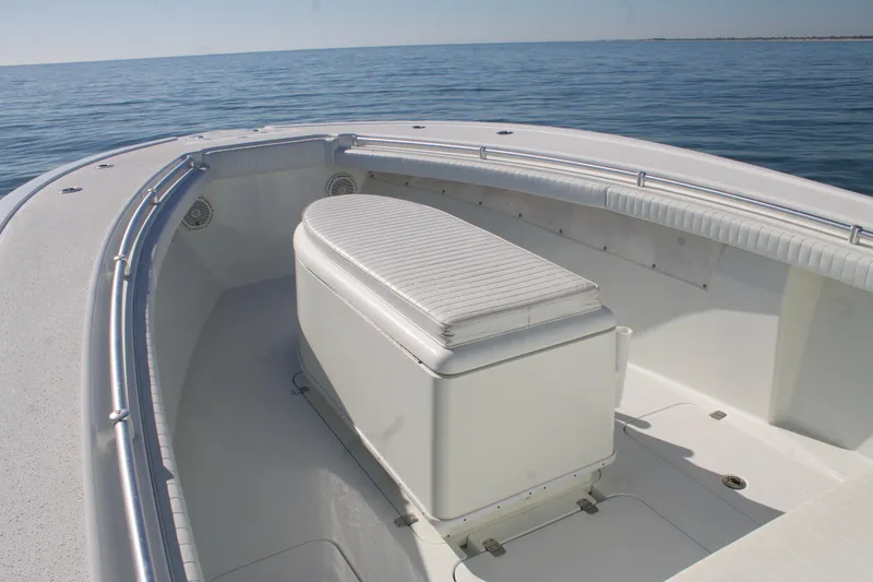 Slide: The Image of 2014 Yellowfin 32 Offshore boat, spacious deck with cushioned seating, on calm ocean waters. - 10
