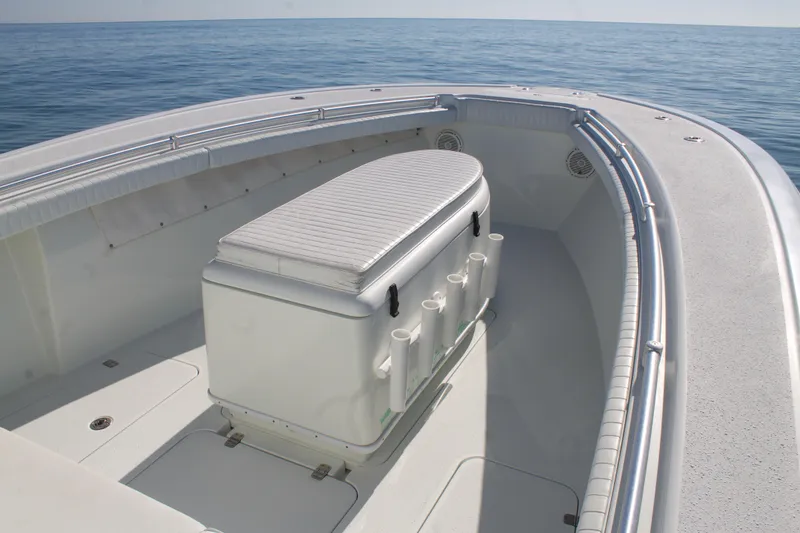 Slide: The Image of 2014 Yellowfin 32 Offshore boat, spacious deck with seating, on calm ocean waters. - 11