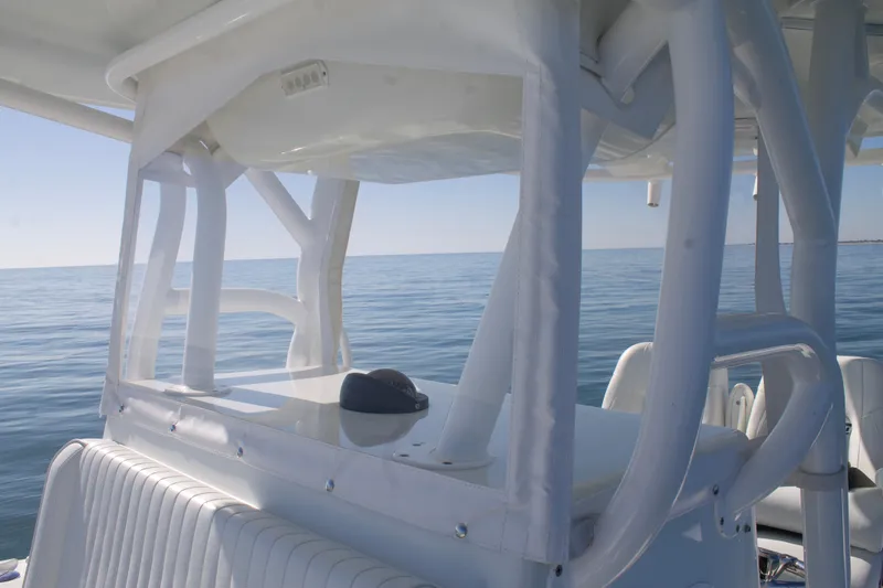 Slide: The Image of 2014 Yellowfin 32 Offshore boat on calm ocean waters, featuring a sleek white design. - 18