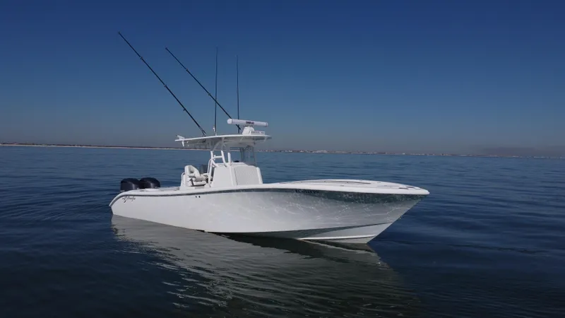 Slide: The Image of 2014 Yellowfin 32 Offshore boat on calm water under clear blue sky. - 2