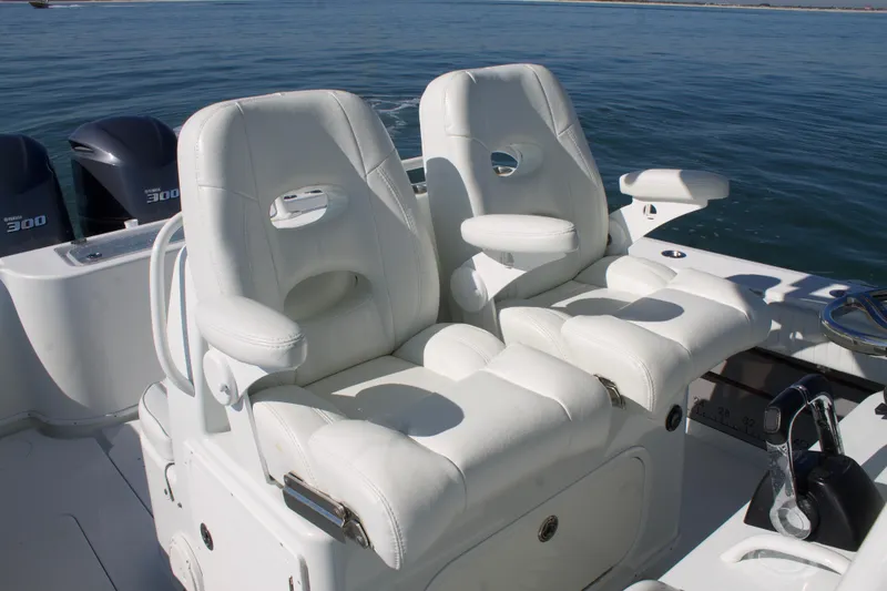 Slide: The Image of 2014 Yellowfin 32 Offshore boat with white cushioned seats and dual outboard motors. - 26