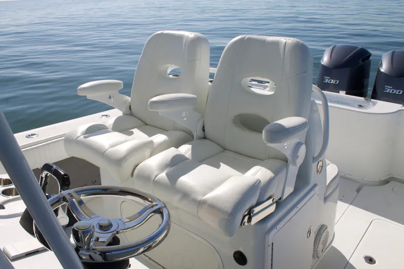 Slide: The Image of 2014 Yellowfin 32 Offshore boat with dual white seats and steering wheel. - 27