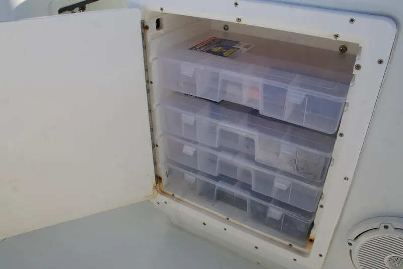 Slide: The Image of Storage compartment with tackle boxes on a 2014 Yellowfin 32 Offshore boat. - 28