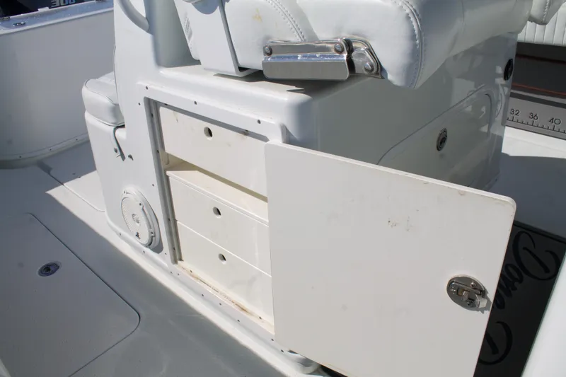 Slide: The Image of 2014 Yellowfin 32 Offshore boat storage compartment with open door and white seating. - 29