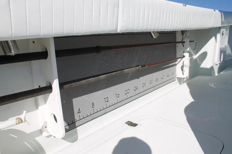 Slide: The Image of 2014 Yellowfin 32 Offshore boat with built-in fishing rod holders and measurement scale. - 31