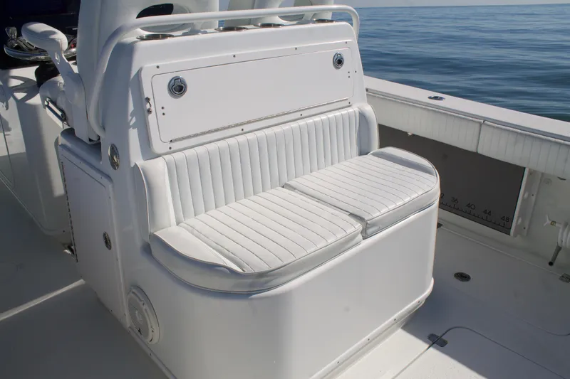 Slide: The Image of 2014 Yellowfin 32 Offshore boat seating, white cushioned bench, ocean background. - 32