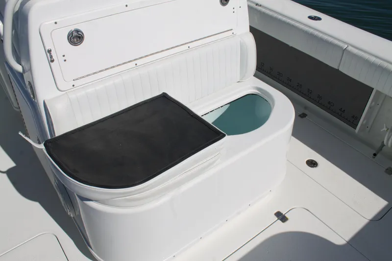 Slide: The Image of 2014 Yellowfin 32 Offshore boat seating with storage compartment and open hatch. - 33