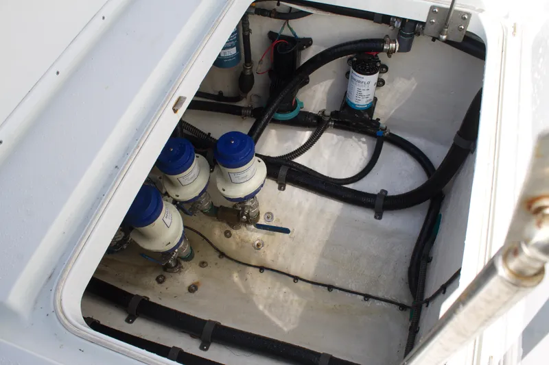 Slide: The Image of 2014 Yellowfin 32 Offshore boat engine compartment with filters and hoses. - 37