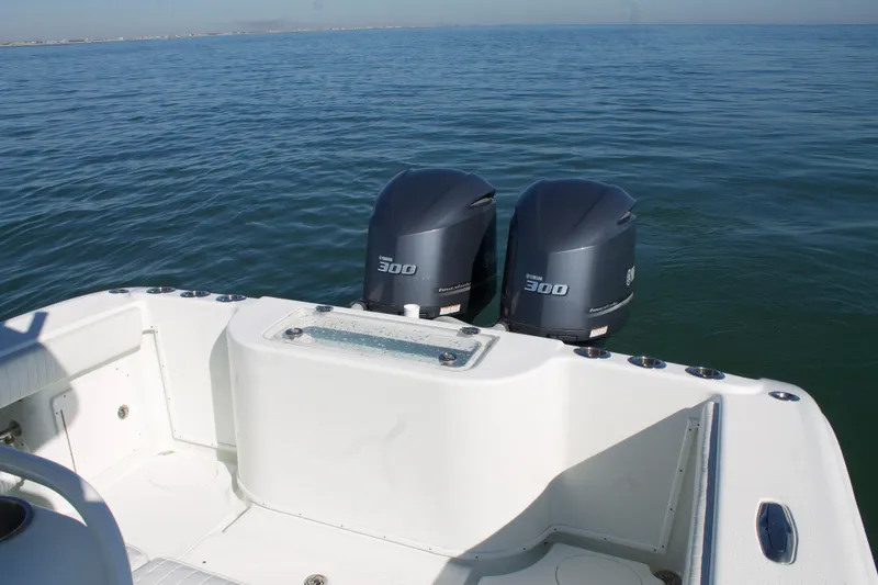 Slide: The Image of 2014 Yellowfin 32 Offshore boat with twin 300 horsepower engines on calm water. - 38