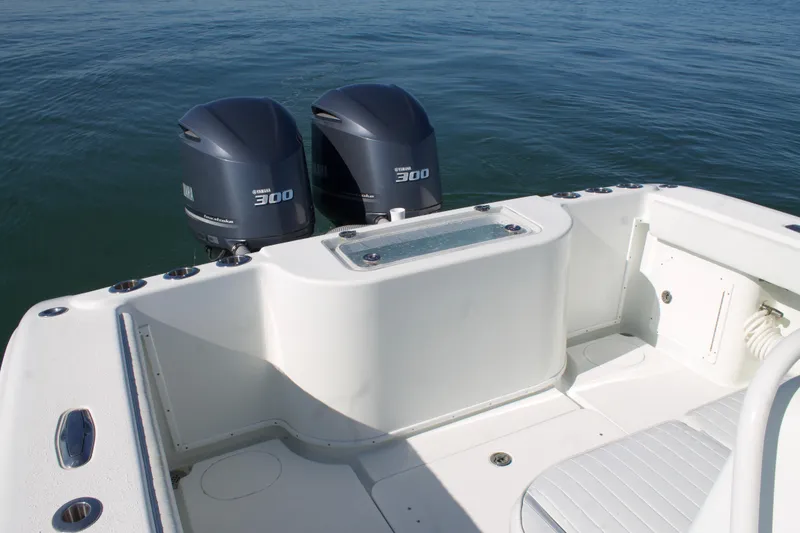 Slide: The Image of 2014 Yellowfin 32 Offshore boat with twin 300 horsepower engines on calm water. - 39