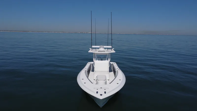 Slide: The Image of 2014 Yellowfin 32 Offshore boat on calm ocean waters, clear blue sky. - 8