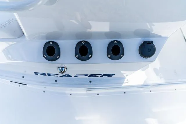 Slide: The Image of Majek 24 Reaper 2025 boat stern with rod holders and logo. - 10