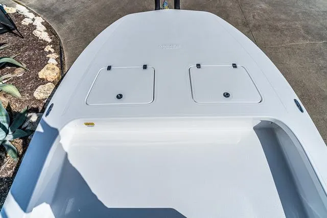 Slide: The Image of 2025 Majek 24 Reaper boat deck with storage compartments, concrete background. - 11