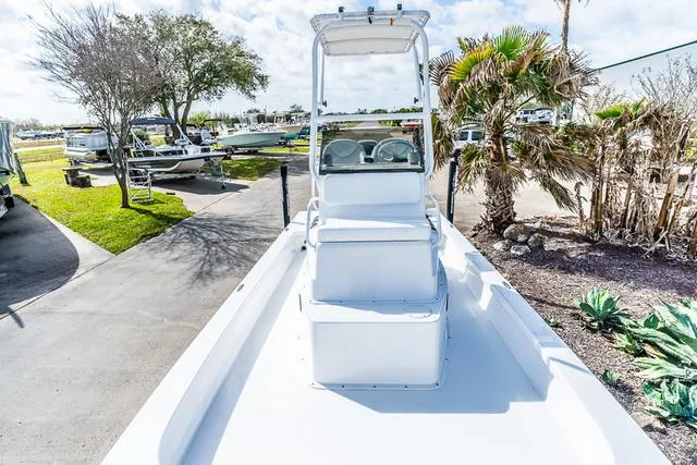 Slide: The Image of 2025 Majek 24 Reaper boat with center console, parked outdoors on a sunny day. - 12