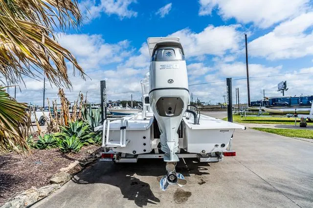 Slide: The Image of 2025 Majek 24 Reaper boat with powerful 350 engine, parked outdoors. - 4