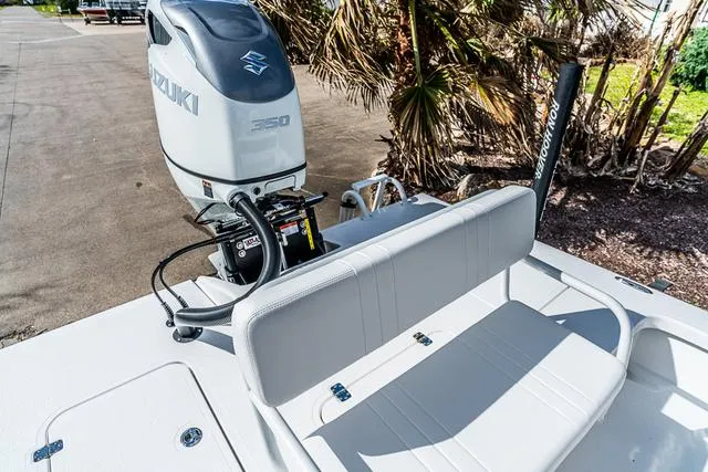 Slide: The Image of 2025 Majek 24 Reaper boat with Suzuki 350 engine, parked near palm trees. - 6