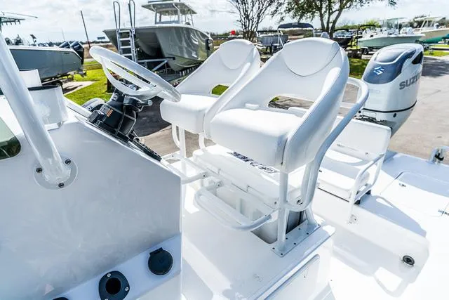 Slide: The Image of 2025 Majek 24 Reaper boat interior with dual white seats and steering console. - 9