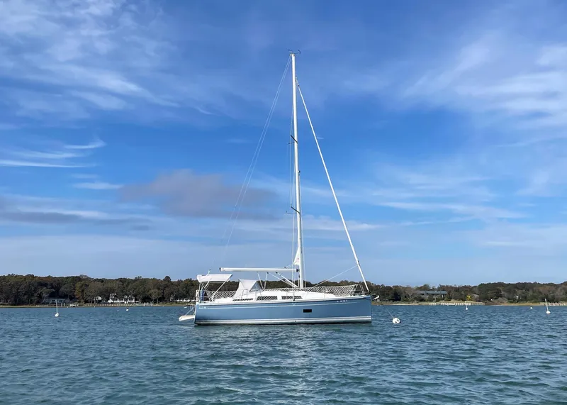 Slide: The Image of 2018 Hanse 348 sailboat on calm water under a clear blue sky. - 0