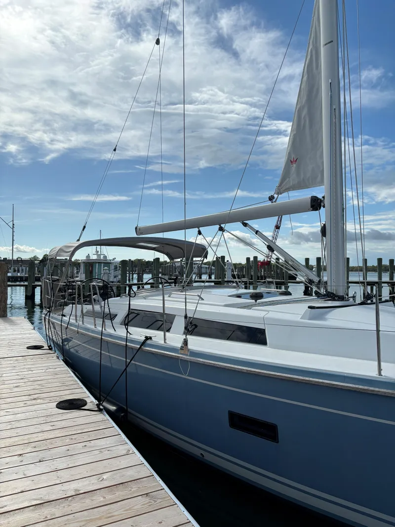 Slide: The Image of 2018 Hanse 348 sailboat docked under a partly cloudy sky. - 4