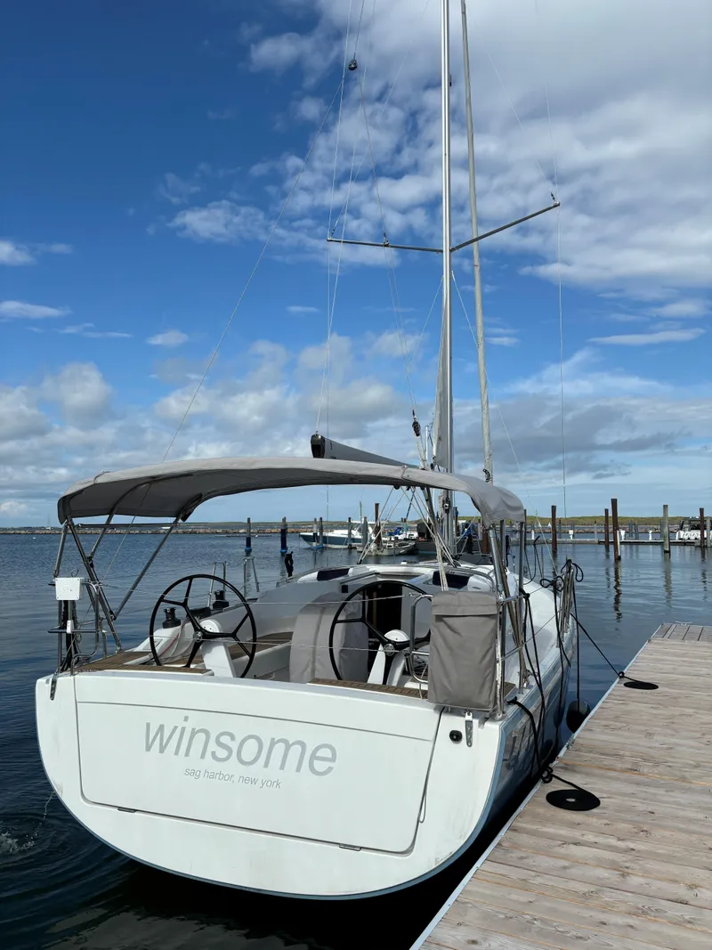 Slide: The Image of 2018 Hanse 348 sailboat docked under a blue sky. - 5
