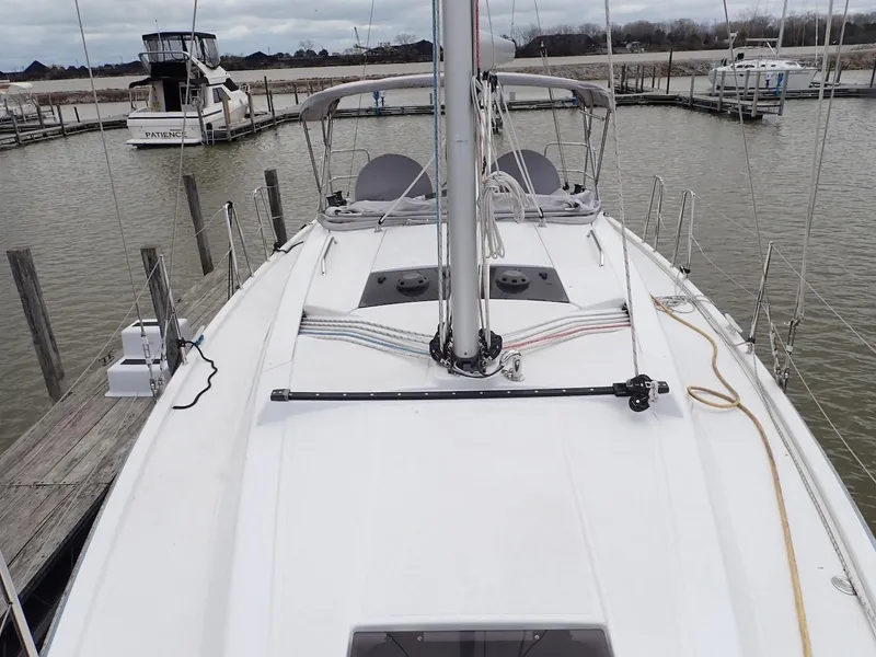 Slide: The Image of 2018 Hanse 348 sailboat docked at a marina, showcasing its deck and rigging. - 6