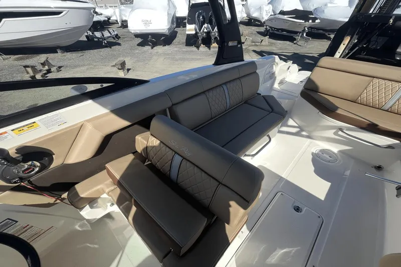 Slide: The Image of 2017 Sea Ray 270SDX boat interior with beige seating and steering wheel. - 14