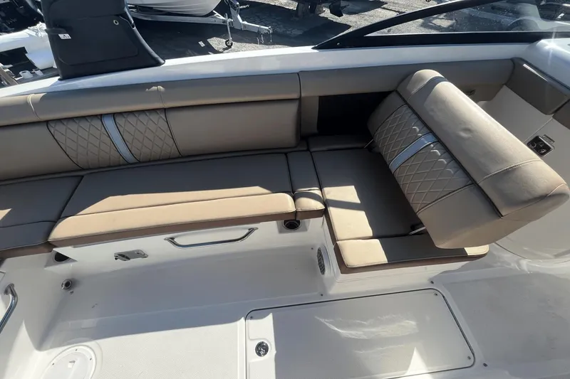 Slide: The Image of 2017 Sea Ray 270SDX boat interior with beige seating and quilted design. - 15
