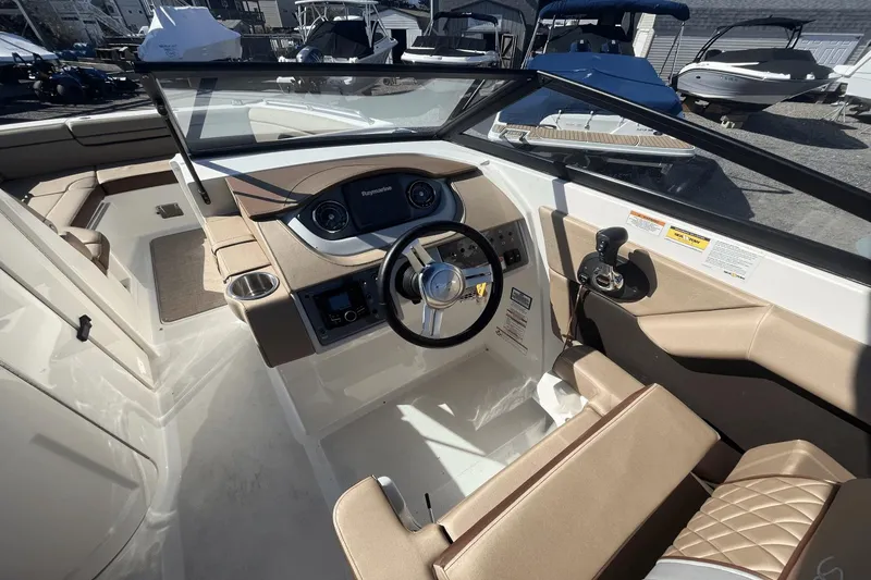 Slide: The Image of 2017 Sea Ray 270SDX boat interior with steering wheel and dashboard controls. - 18