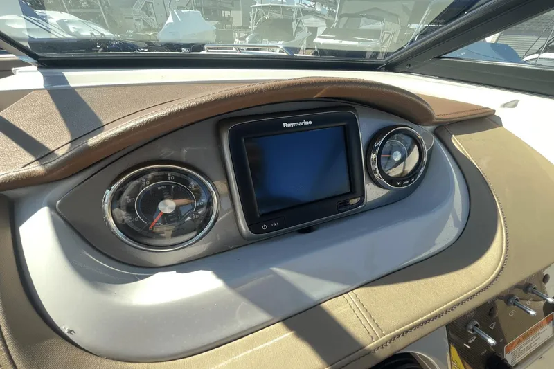 Slide: The Image of Dashboard of a 2017 Sea Ray 270SDX boat with Raymarine display and gauges. - 19