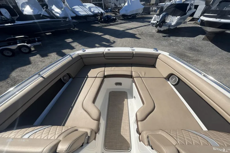 Slide: The Image of 2017 Sea Ray 270SDX boat interior with tan seating, docked among other boats. - 22