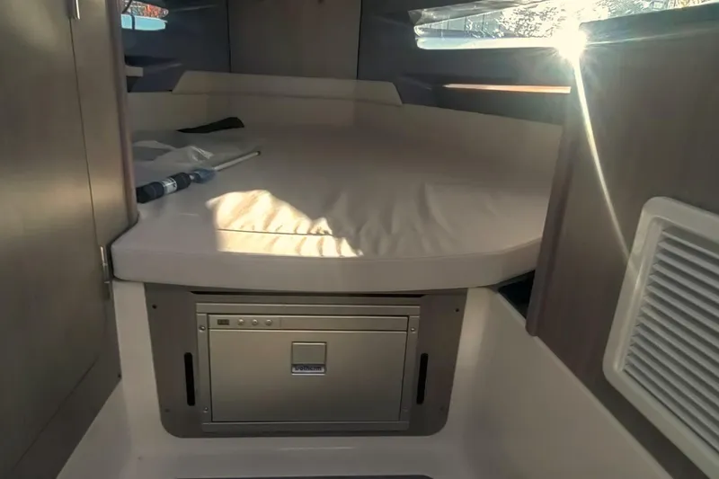 Slide: The Image of Navan C30 2025 boat, side view, sleek design, white and black color scheme. - 11