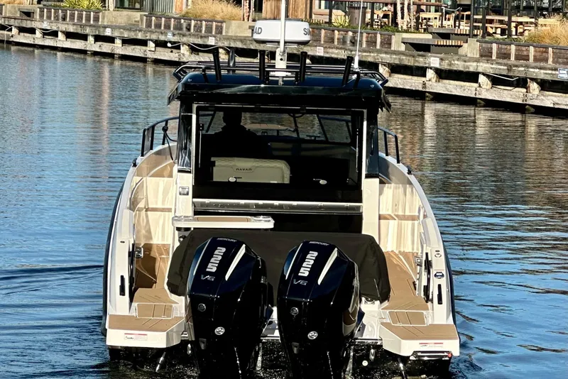 Slide: The Image of 2026 Navan C30 boat with dual outboard engines on a calm waterway. - 3