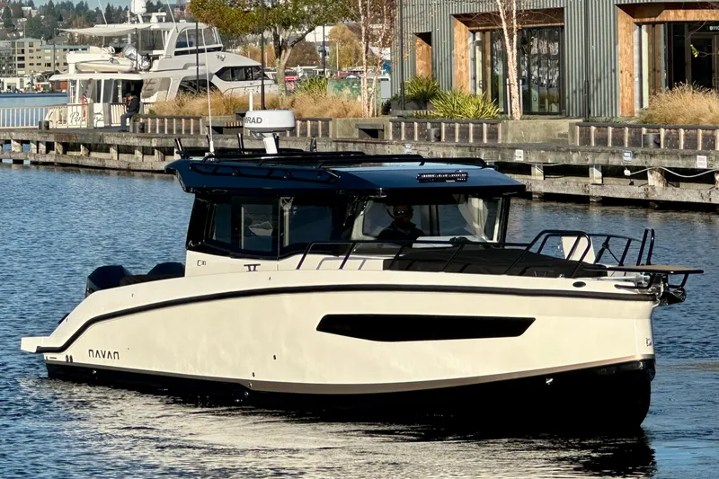 Slide: The Image of Modern 2026 Navan C30 boat cruising near a dockside building. - 4