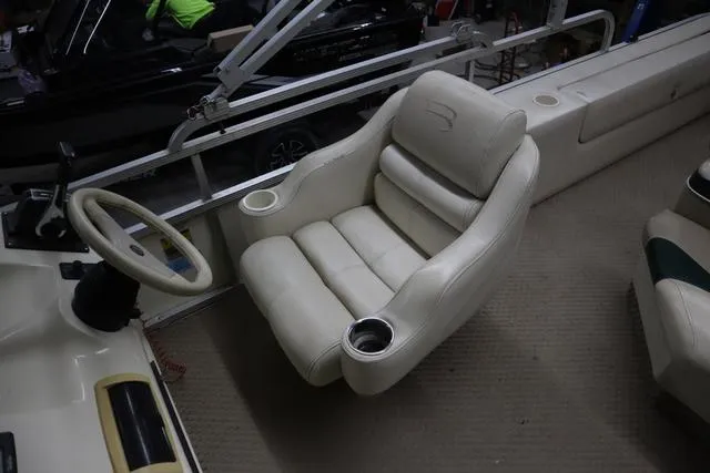 Slide: The Image of Luxurious seating on a 2002 Bennington 2275 FSI boat with cup holders and steering wheel. - 11