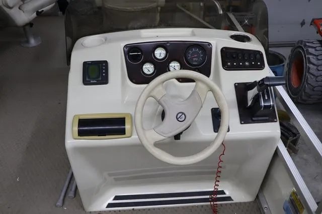 Slide: The Image of Console of a 2002 Bennington 2275 FSI boat with steering wheel and gauges. - 12
