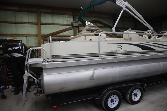 Slide: The Image of 2002 Bennington 2275 FSI pontoon boat on trailer in indoor storage. - 3