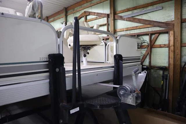 Slide: The Image of 2002 Bennington 2275 FSI pontoon boat stored indoors on a trailer. - 4