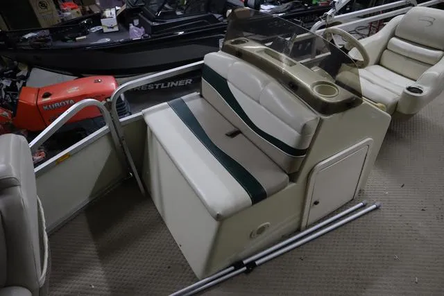 Slide: The Image of 2002 Bennington 2275 FSI boat interior with seating and steering console. - 9
