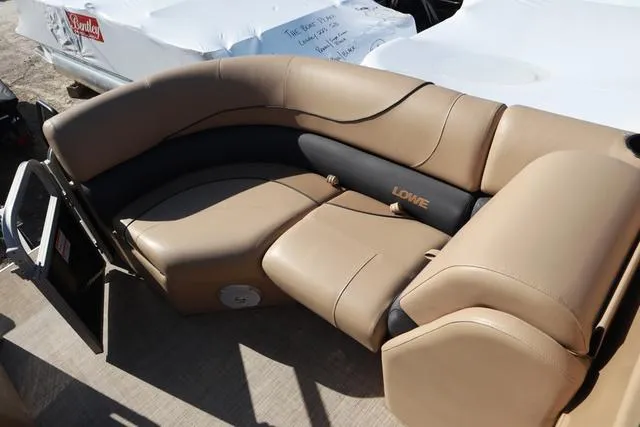 Slide: The Image of 2020 Lowe SS 210 V boat interior with tan seating and black accents. - 10