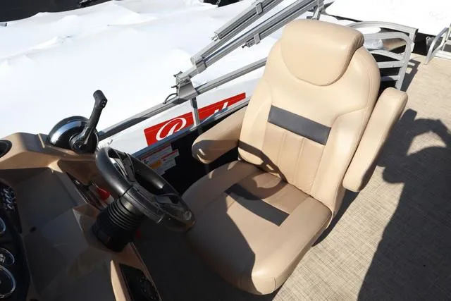 Slide: The Image of Captain's chair and steering wheel on a 2020 Lowe SS 210 V boat. - 13