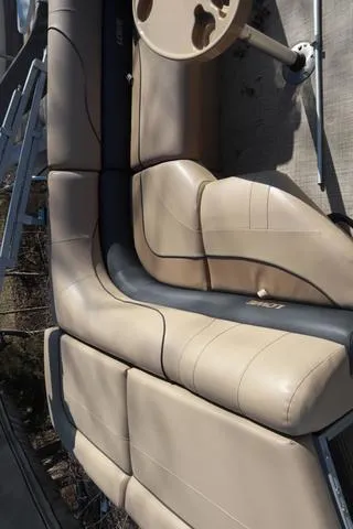 Slide: The Image of Beige seating on 2020 Lowe SS 210 V boat, featuring a round table. - 16