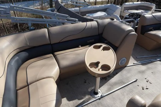 Slide: The Image of 2020 Lowe SS 210 V boat interior with beige seating and cup holders. - 17