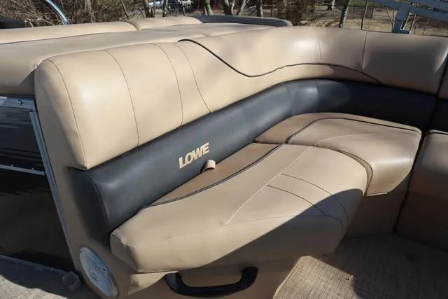 Slide: The Image of 2020 Lowe SS 210 V boat interior with beige and black seating. - 18